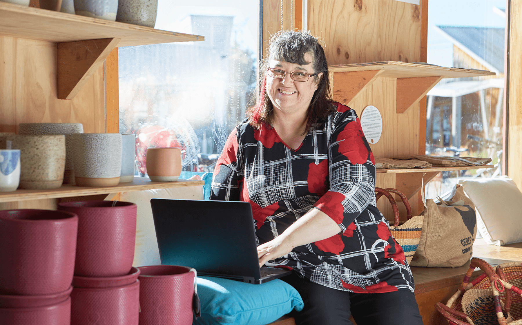 A-woman-sitting-in-a-cafe-with-a-loptop