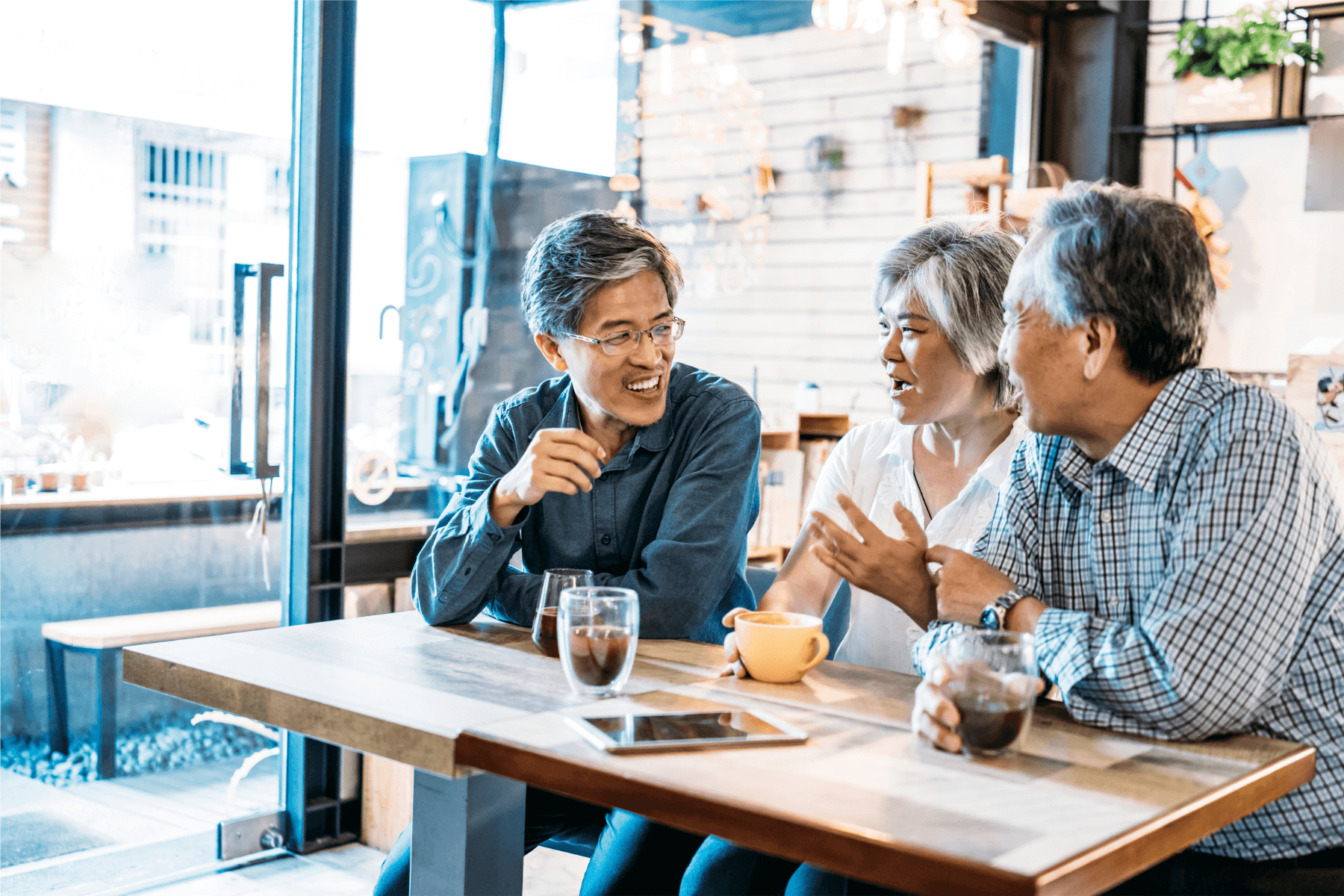 Three-people-talking-at-cafe-with-coffee